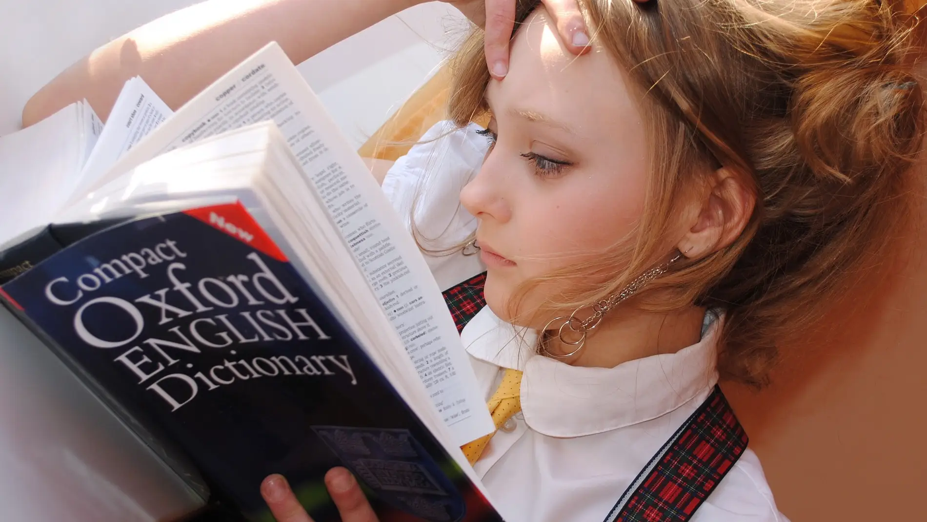 Una chica con un diccionario de inglés.