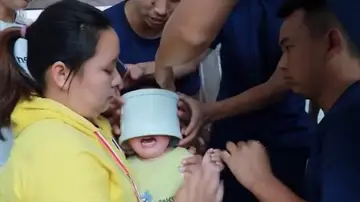 Bomberos chinos liberan la cabeza de un niño de una tubería