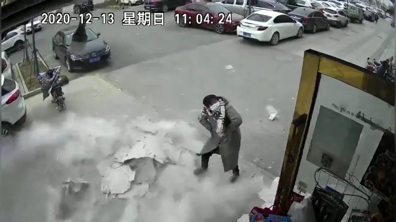 Una mujer esquiva por poco una pared que casi le cae encima