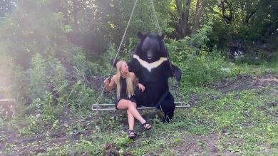 Una mujer se columpia con un oso gigante en Siberia