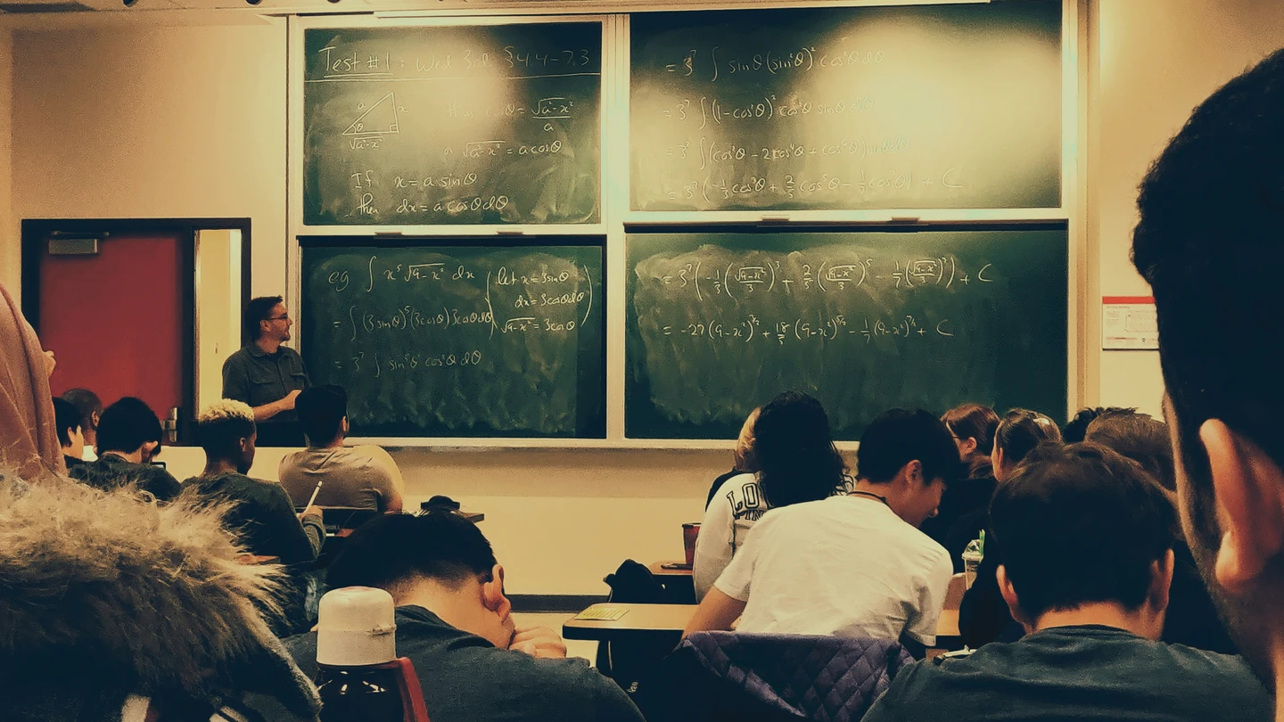Un profesor explicando frente a una clase Un profesor explicando frente a una clase