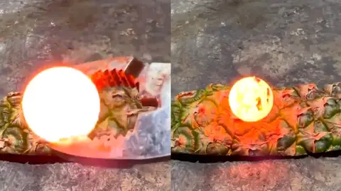 Ponen una bola al rojo vivo sobre una piña Ponen una bola al rojo vivo sobre una piña
