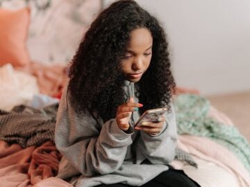 Imagen de una chica usando su tel&eacute;fono m&oacute;vil